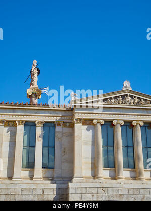 Lateral facade detail of The Academy of Athens. Greece National academy with the Athena column and greek flag in the background. Athens. Attica region Stock Photo