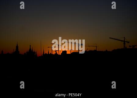 Moscow, Russia - July 21, 2017: a sunset over silhouette of Moscow's iconic church on Red Square with about 10 construction cranes in view Stock Photo