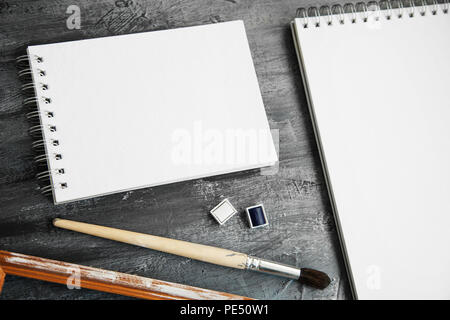 Artistic notepads with empty pages on black wood table background for portfolio design Stock Photo
