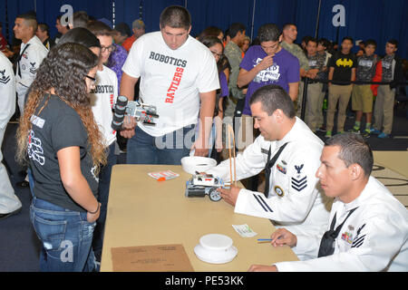 During Robotics Day at the 2015 Hispanic Engineering, Science, and Technology Week in Edinburg, Texas, Navy recruiters oversaw students using Lego Mindstorms EV3 kits to design, build, and program robots. The event engaged sixth through tenth graders in STEM education, showcasing engineering, programming, and problem-solving skills. Participants demonstrated creativity and technical proficiency while Navy representatives provided mentorship and guidance on science, technology, engineering, and math applications and careers. Stock Photo