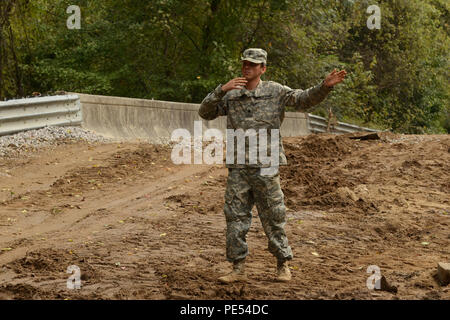The 1782nd Engineer Company of the South Carolina National Guard directs delivery of fill material and performs road repairs on Whitehouse Road near the Richland Wastewater Treatment Plant in Columbia. Operations focus on restoring transportation infrastructure, supporting community access, coordinating with local emergency management, and ensuring safety while demonstrating readiness and engineering capability during flood recovery. Stock Photo