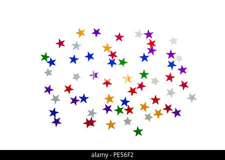 Colourful foil stars laid in an abstract pattern on white. Stock Photo