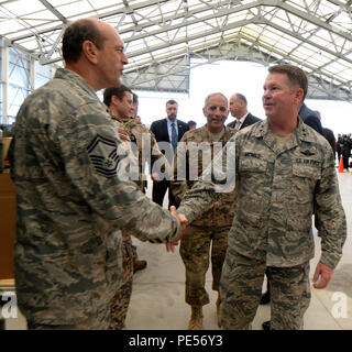 Maj. Gen. John Nichols, Adjutant General of Texas, shakes hands with Senior Master Sgt.Wendell Duplechin, with the 147th Reconnaissance Wing, Texas Air National Guard, during media day Sept. 8, 2015, at Lielvarde Air Base, Latvia. Officials invited distinguished guests and media to the air base to learn more about the 147th Reconnaissance Wing, Texas Air National Guard, and the Michigan National Guard's mission to fly the reconnaissance aircraft in its first non-combat deployment and its first flight in European air space. (Air National Guard photo by 1st Lt. Alicia Lacy/Released) Stock Photo