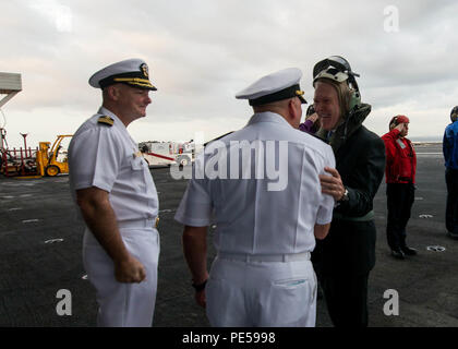 151001-N-EM227-022 TOKYO BAY, Japan (Oct. 1, 2015) Capt. Christopher Bolt, left, and Rear Adm. John Alexander, center, commander, Battle Force 7th Fleet, shake hands with Secretary of the Navy (SECNAV) Ray Mabus during a visit aboard the U.S. Navy’s only forward-deployed aircraft carrier USS Ronald Reagan (CVN 76). Ronald Reagan and its embarked air wing, Carrier Air Wing (CVW) 5, provide a combat-ready force that protects the collective maritime interests of its allies and partners in the Indo-Asia-Pacific Region. (U.S. Navy photo by Mass Communication Specialist Seaman Sara B. Sexton/Release Stock Photo