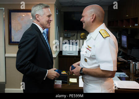 151001-N-TE278-034 TOKYO BAY (Oct. 1, 2015) Secretary of the Navy (SECNAV) Ray Mabus speaks with Rear Adm. John Alexander, commander, Battle Force 7th Fleet, aboard the U.S. Navy's only forward-deployed aircraft carrier USS Ronald Reagan (CVN 76) as it arrives to Fleet Activities Yokosuka, Japan. Ronald Reagan and its embarked air wing, Carrier Air Wing (CVW) 5, provide a combat-ready force that protects and defends the collective maritime interests of the U.S. and its allies and partners in the Indo-Asia-Pacific region. (U.S. Navy photo by Mass Communication Specialist 2nd Class Paolo Bayas/R Stock Photo