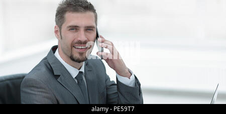 closeup.businessman working on laptop and talking on the phone Stock Photo