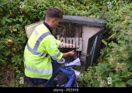 BT Openreach engineer connecting phone lines to fibre broadband in Telford Uk Stock Photo