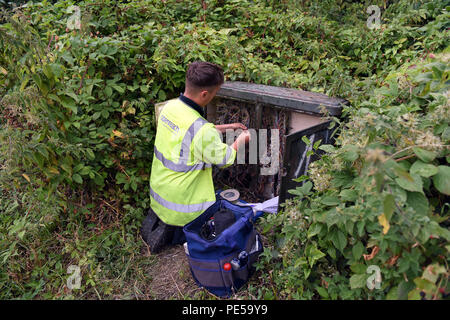 BT Openreach engineer connecting phone lines to fibre broadband in Telford Uk Stock Photo