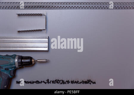 Work tools for profile metal frame assembling. Metal profiles, automatic screwdriver and screws. Plasterboard and insulation installing Stock Photo