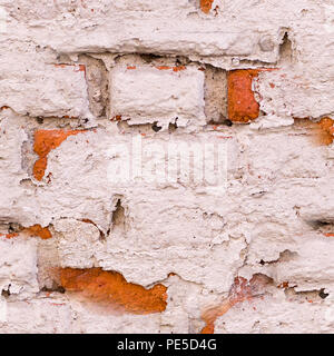 old vintage brick wall with shabby white paint background. architecture, texture. Stock Photo
