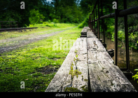 Old canal bridge leading away. Stock Photo