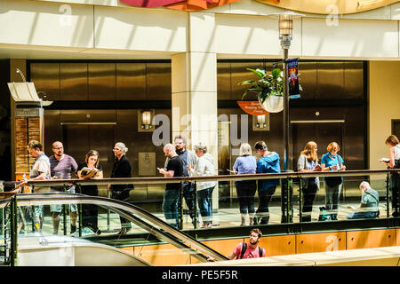 Movie goers waiting in line in front of box office to buy tickets Stock Photo