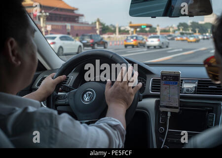 A Didi Premier car drives past the Tiananmen Gate in Beijing, China. Didi Premier offers a higher-end premier mobility experience with luxury vehicles Stock Photo