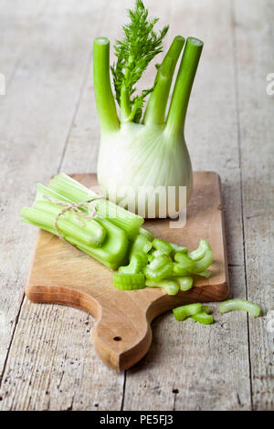 fresh organic celery and fennel on wooden board Stock Photo