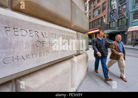 Man walking past the Federal Reserve Bank of New York Stock Photo