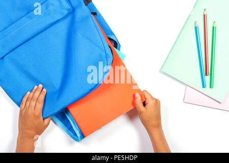 Back to school, education concept. Kid hands packing backpack and preparing for school Stock Photo