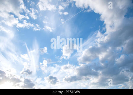 Beautifully sunlit white clouds in the blue sky. Stock Photo