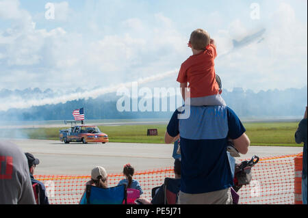 Zach Hagemen and his nephew, Brooks, watch as the Flash Fire Jet Truck speeds down the runway during the Thunder Over South Georgia airshow, Nov. 7, 2015, at Moody Air Force Base, Ga. The jet-powered truck does 0-60 mph in just over one second and has a top speed of 375 miles per hour. (U.S. Air Force photo by Airman 1st Class Kathleen D. Bryant/Released) Stock Photo