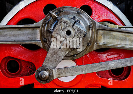 Red wheel of old steam locomotive, closeup shot, industrial background Stock Photo