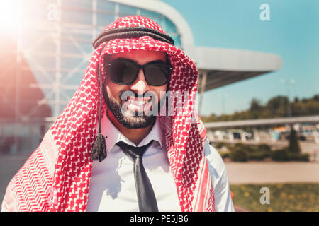 Portrait of arab man wears sunglasses and keffiyeh at the airport Stock Photo