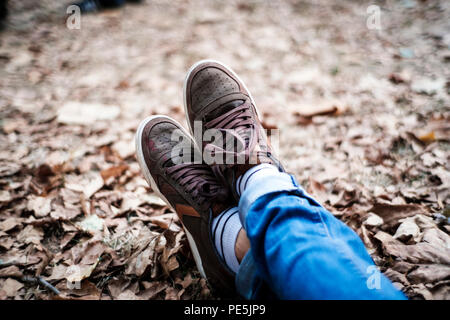 Feet on dried leaves, low DOF Stock Photo
