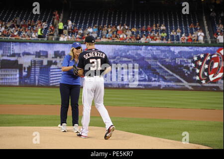 Deborah Lee James, secretary of the Air Force, passes the game ball to Max Scherzer at Nationals Park, Washington D.C. on Sept. 18, 2015. Scherzer is a pitcher on the Washington Nationals baseball team. (Air Force photo by Staff Sgt. Whitney Stanfield) Stock Photo