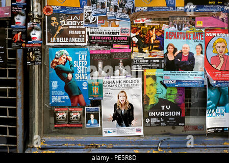 Posters stuck on the window of an empty shop advertising shows on the Edinburgh Fringe Festival, Edinburgh, Scotland, UK. Stock Photo