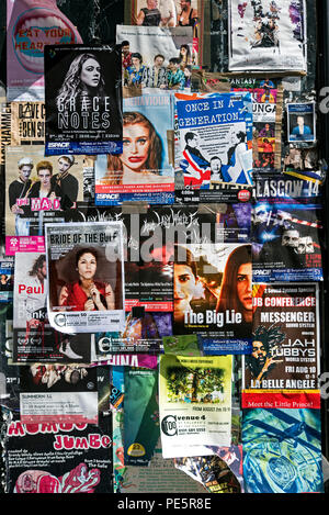 Posters stuck on the window of an empty shop advertising shows on the Edinburgh Fringe Festival, Edinburgh, Scotland, UK. Stock Photo