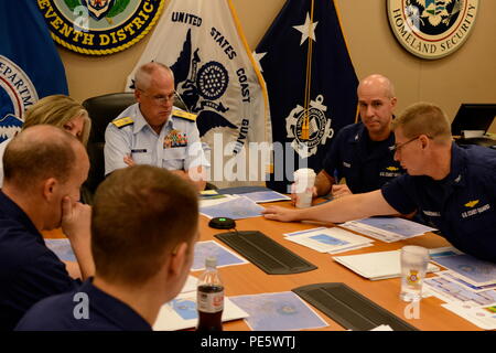 Rear Adm. Scott Buschman, commander of the Coast Guard 7th District, receives an update brief for the missing cargo ship El Faro at the Coast Guard 7th District in Miami Oct. 3, 2015. Coast Guard search crews have covered more than 850 square nautical miles in the search for the El Faro crew.  (Coast Guard photo by Petty Officer 2nd Class Jon-Paul Rios) Stock Photo