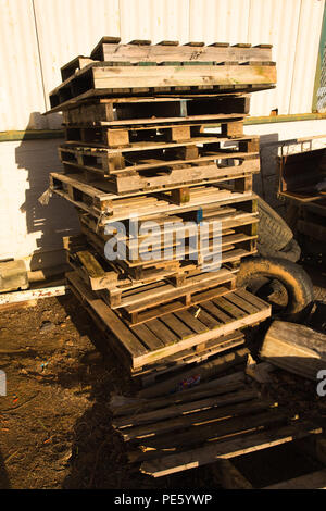 tower or stack of wooden pallets stored outside a shed on a wine estate Stock Photo