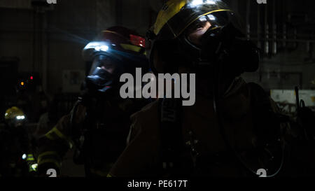 151005-N-OE749-055 NAVAL AIR FACILITY ATSUGI, Japan (Oct. 5, 2015) Daisuke Midorikawa, assigned to Commander, Navy Region Japan (CNRJ) Fire Department, prepares to combat a simulated fire during a joint drill at Fleet Readiness Center Western Pacific Support Equipment Rework Facility. The evolution is held semi-annually to improve interoperability between firefighters from CNRJ Regional, Japanese Maritime Self Defense Force, Yamato City and Ayase City. (U.S. Navy photo by Mass Communication Specialist 1st Class Barry A. Riley/RELEASED) Stock Photo