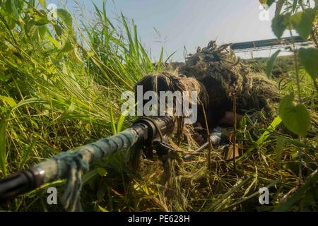 Philippine Marine Corps Cpl. Rosewel L. Bedaña, scout sniper with 64th Force Reconnaissance Company, Marine Special Operation Forces Group, sights in during an amphibious raid at Ternate, Philippines, as a part of Amphibious Landing Exercise 2015 (PHIBLEX 15), Oct. 8. PHIBLEX 15 is an annual bilateral training exercise conducted with the Armed Forces of the Philippines in order to strengthen our interoperability and working relationships across a wide range of military operations from disaster relief to complex expeditionary operations. (U.S. Marine Corps photo by Lance Cpl. Juan Bustos/ Relea Stock Photo