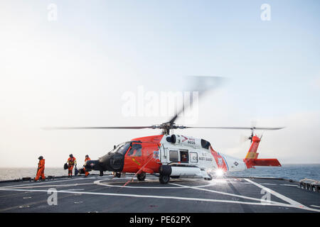 An HH-60 Jayhawk rescue helicopter from Coast Guard Air Station Kodiak in Kodiak, Alaska lands on the flight deck of Coast Guard Cutter Healy, Oct. 7, 2015, while underway in the southern Arctic Ocean. Healy is underway in the Arctic Ocean in support of the National Science Foundation-funded Arctic GEOTRACES, part of an international effort to study the distribution of trace elements in the world's oceans. (U.S. Coast Guard photo by Petty Officer 2nd Class Cory J. Mendenhall) Stock Photo