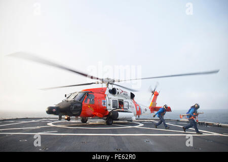 An HH-60 Jayhawk rescue helicopter from Coast Guard Air Station Kodiak in Kodiak, Alaska lands on the flight deck of Coast Guard Cutter Healy, Oct. 7, 2015, while underway in the southern Arctic Ocean. Healy is underway in the Arctic Ocean in support of the National Science Foundation-funded Arctic GEOTRACES, part of an international effort to study the distribution of trace elements in the world's oceans. (U.S. Coast Guard photo by Petty Officer 2nd Class Cory J. Mendenhall) Stock Photo