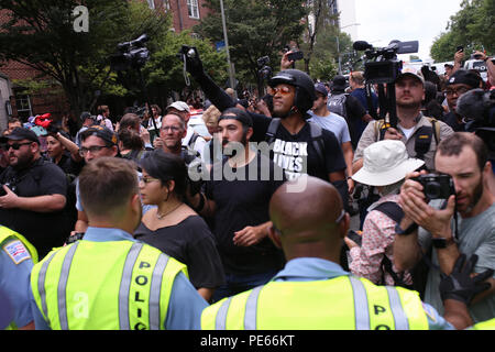 Washington, DC, USA. 12 Aug 2018. Counterprotestors at the Unite the Right protest march in front of the police escort. Credit: Joseph Gruber/Alamy Live News Stock Photo