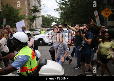 Washington, DC, USA. 12 Aug 2018. Counterprotestors at the Unite the Right protest march along with the police escort voicing their anger at the protestors. Credit: Joseph Gruber/Alamy Live News Stock Photo