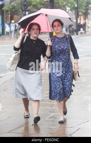 London UK. 13th August 2018. UK Weather: Shoppers in Oxford Street are caught in heavy rain showers Credit: amer ghazzal/Alamy Live News Stock Photo