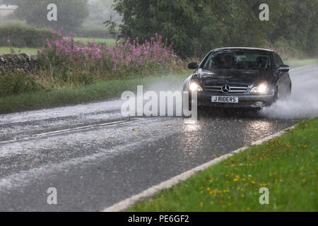 Barnard Castle, Teesdale, County Durham, UK.  Monday 13th August 2018.  UK Weather.  Torrential rain has flooded some roads in the area around Barnard Castle this afternoon, creating hazardous driving conditions. Credit: David Forster/Alamy Live News Stock Photo