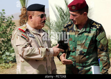 Iraqi army Staff Gen. Riyadh Talal Tawfiq, center, briefs Secretary of ...