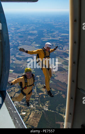 Golden Knights candidates Staff Sgt. Nicholas Berkner (left) and Spc. Joe Bradshaw (right) exit a UV-18 Twin Otter aircraft over Laurinburg, N.C., to practice a skydiving maneuver called diamond tracking during tryouts to become a member of the U.S Army Parachute Team the Golden Knights. (U.S. Army photo by Staff Sgt. David Meyer, 49th Public Affairs Detachment/Released) Stock Photo