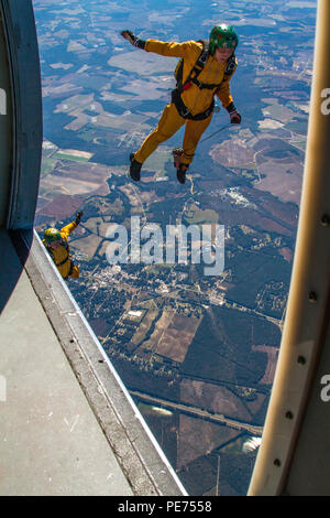 Golden Knights candidates Sgt. 1st Class Cory Rush (bottom) and Sgt. Shana Greene (top) exit a UV-18 Twin Otter aircraft over Laurinburg, N.C., to practice a skydiving maneuver called diamond tracking during tryouts to become a member of the U.S Army Parachute Team the Golden Knights. (U.S. Army photo by Staff Sgt. David Meyer, 49th Public Affairs Detachment/Released) Stock Photo