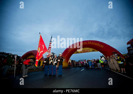 U.S. Marines present the American and Marine Corps flag before the Marine Corps Marathon at Arlington, Va., Oct. 25, 2015. Over 30,000 runners participated in the 26.2 mile, 40th annual Marine Corps Marathon. (U.S. Marine Corps photo by Sgt. Gabriela Garcia/Released) Stock Photo