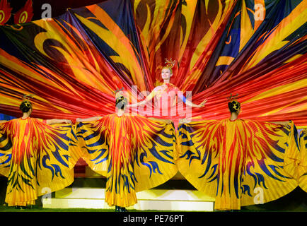 Dancers depict peacocks, butterflies and blossoms with the tapestry they twirl in a dance previewing the culture of Wuhan, capital city of central China's Hubei province, where the next CISM World Games will be held in 2019. The dance was part of closing ceremonies for the 6th CISM World Games in MunGyeong, South Korea, Oct. 11, 2015. Stock Photo