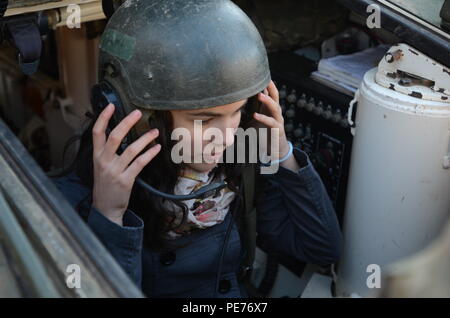 Nora Pop, from Cluj-Napoca, Romania, wears a communications helmet while sitting in the driver’s seat of a U.S. Army Infantry Carrier Variant (Stryker) at the static display in Arad, Romania, Oct. 25, 2015. The static display was part of many events that took place on the Romania National Army Day in and around Arad, Romania, Oct. 25, 2015. The events are also a part of Exercise Dragoon Crossing which is in support of Operation Atlantic Resolve, an ongoing series of training exercises and events designed to build relationships, trust and interoperability between the U.S. and its NATO allies. ( Stock Photo