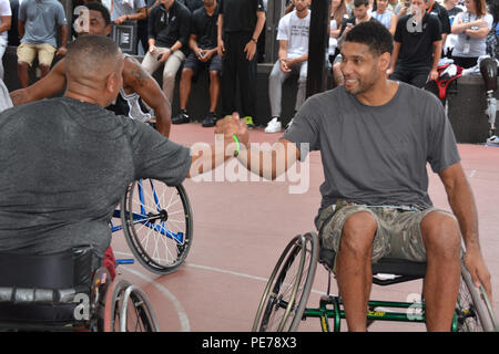 San Antonio Spurs center Tim Duncan shakes hands with a wounded warrior after a game of wheelchair basketball Oct. 21 at the Center for the Intrepid. (U.S. Army photo by Robert T. Shields/Released) Stock Photo