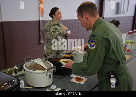 Col. Gentry Boswell, 28th Bomb Wing commander, dishes out chili at the Combined Federal Campaign Chili Cook-Off at Ellsworth Air Force Base, S.D., Oct. 26, 2015. The event proceeds were donated to the CFC, which benefits charities all over the world. (U.S. Air Force photo by Airman 1st Class James L. Miller/Released) Stock Photo