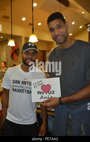 San Antonio Spurs guard Patty Mills and center-forward Tim Duncan show their appreciation to fans during a visit to Brooke Army Medical Center, Oct. 21. The Spurs visited warriors and family members at the Warrior and Family Support Center and the Center For the Intrepid. Players signed autographs and participated in a game of wheelchair basketball. (U.S. Army photo by Robert T. Shields/Released) Stock Photo