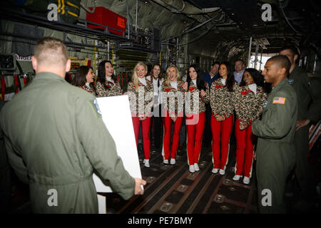 Airmen from the 37th Airlift Squadron shares jokes with Kansas City Chiefs cheerleaders during a base tour Nov. 2, 2015, at Ramstein Air Base, Germany. The cheerleaders are slated to return to perform and provide a clinic for the families of the Kaiserslautern Military Community. (U.S.  Air Force photo/Staff Sgt. Armando A. Schwier-Morales) Stock Photo