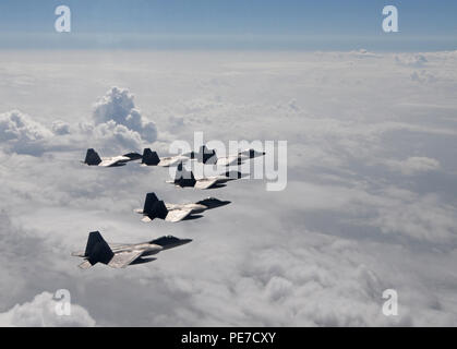 Six F-22 Raptors from the 95th Fighter Squadron from Tyndall Air Force Base, Fla., fly over the Gulf of Mexico Nov. 5 during a local training mission. The group of six F-22s were part of a large group formation of 15 Raptors. Stock Photo