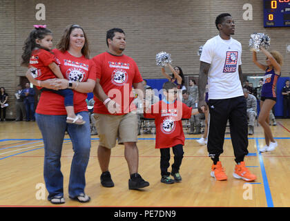 Eric Bledsoe, Phoenix Suns guard, escorts the Rodriguez family through the Bryant Fitness Center Nov. 5, 2015, on Luke Air Force Base, Ariz. The players each escorted family members of fallen heroes before their practice demonstration. (U.S. Air Force photo by Staff Sgt. Marcy Copeland) Stock Photo